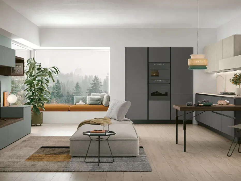 A kitchen in step with the times and the pace of the city, where even smart working finds its dedicated space. Basalto, Giada, Topazio, Pietra Ghiaia, Sapienstone Ivory countertop.
